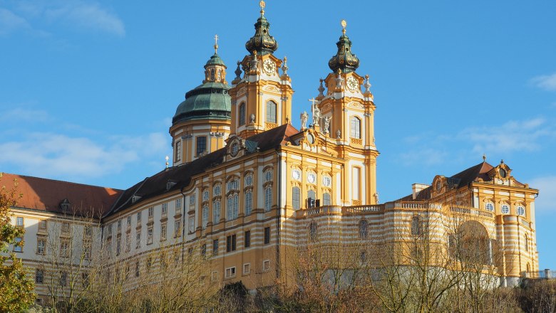 Barockes Klostergebäude mit Türmen und Kuppeln vor blauem Himmel., © Donau NÖ Tourismus_JMZ